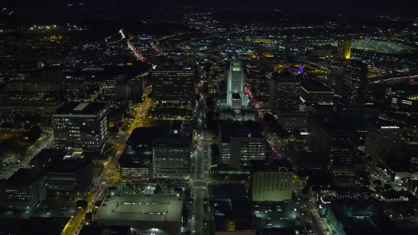 Night aerial footage overlooking Los Angeles City Hall in Downtown LA during summer