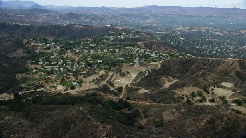 Aerial footage of a neighborhood nestled in the hillside of Topanga California captured during the daytime