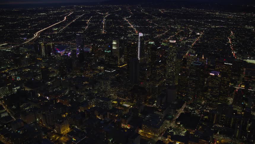 Stunning aerial view of Downtown Los Angeles California at night showcasing the citys impressive skyline and lit-up skyscrapers