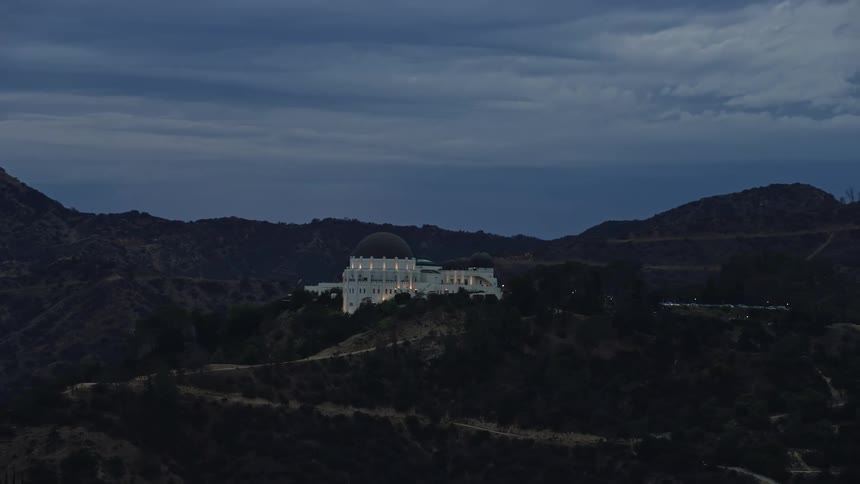 Aerial footage orbiting the Griffith Observatory during twilight in Los Angeles California