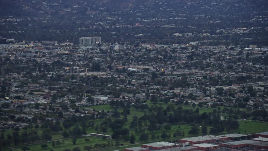 A private jet takes off during twilight from Burbank airport in California captured from a aerial perspective
