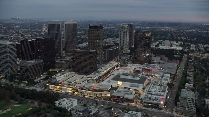 An awe-inspiring aerial view of towering office buildings and vibrant shopping malls during twilight over Century City California