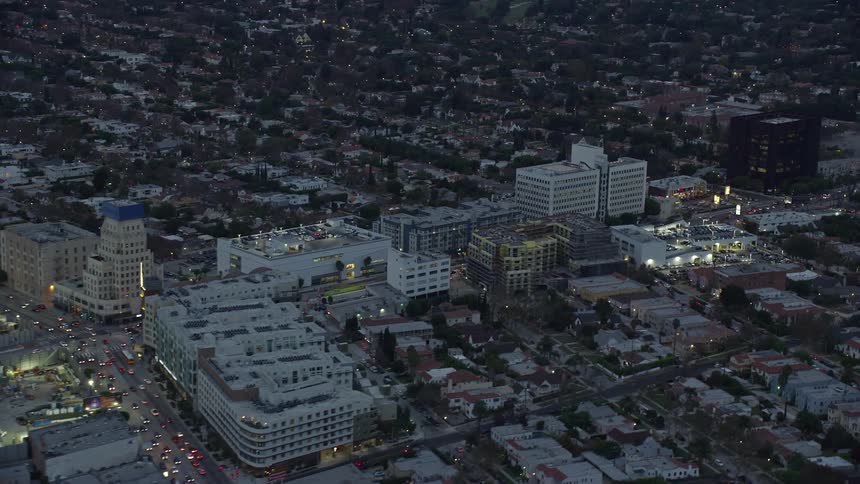 A breathtaking aerial view of Wilshire La Brea apartments and Consulate General of Spain on Wilshire Boulevard at twilight in Central Los Angeles captured during summer