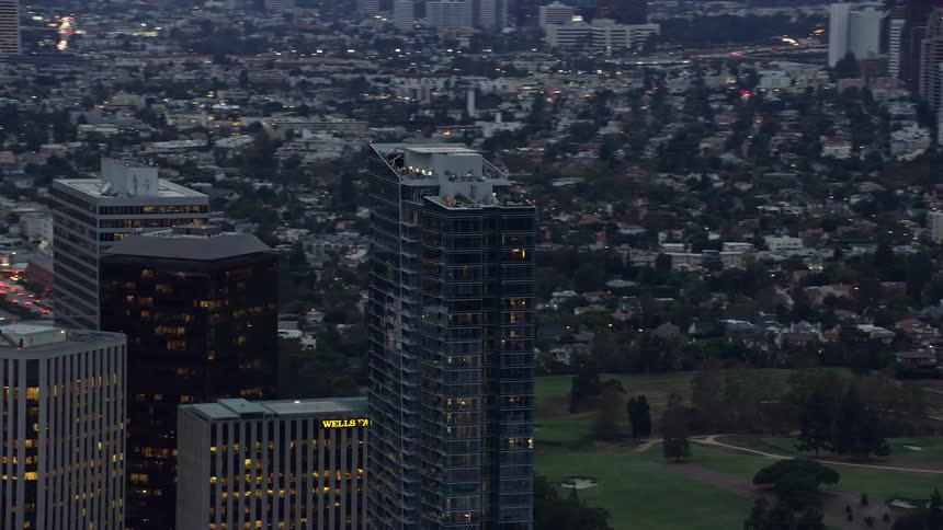 An Orbiting aerial view of Ten Thousand a luxury condominium building in Century City Los Angeles shot during twilight hours in California