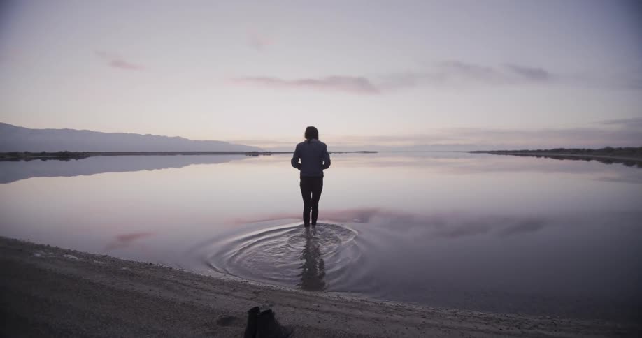 A woman walks into the water