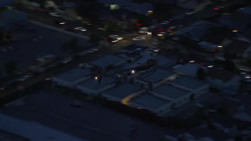 Tracking an LAPD helicopter flying over Hollywood California at twilight
