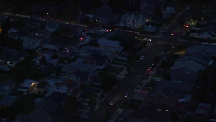An LAPD helicopter flies over Hollywood California at twilight captured in stunning aerial stock footage