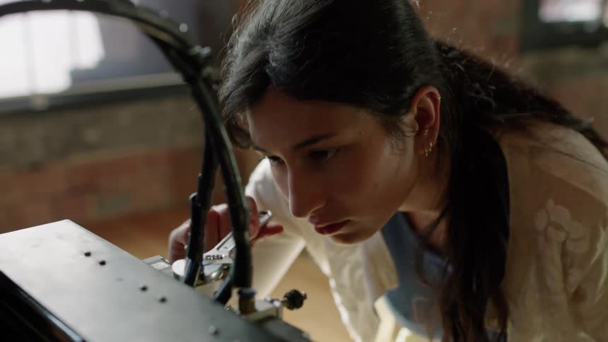 Woman uses wrench to tighten connection