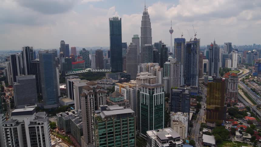An aerial view of skyscrapers in a dense metropolis on a cloudy day