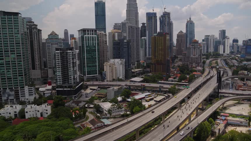 A stretch of highway near a metropolitan area is cleared for a large group of bicyclists