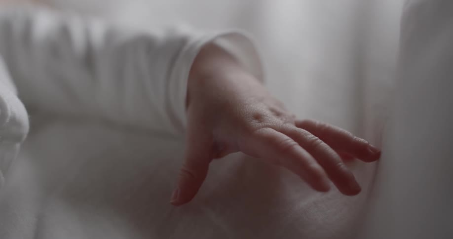 Young person's hand and sleeve all in white