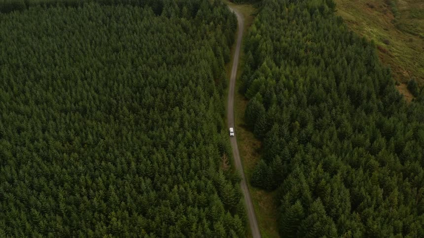 Aerial view of a car driving through a rural area