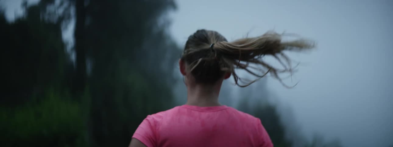 Active Woman Running in the Majestic Mountains