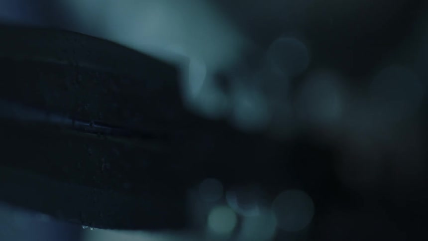 A person is holding a sword in the rain