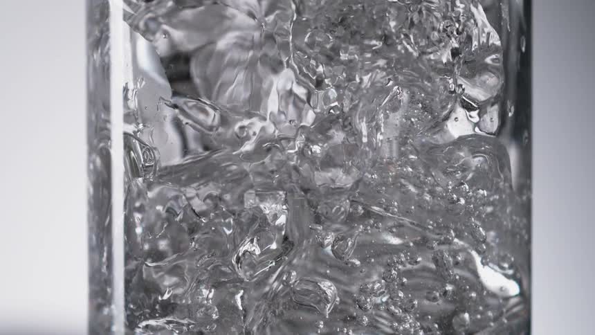 A bubble of water suspended in mid air inside a cage made of nyon or nylon material