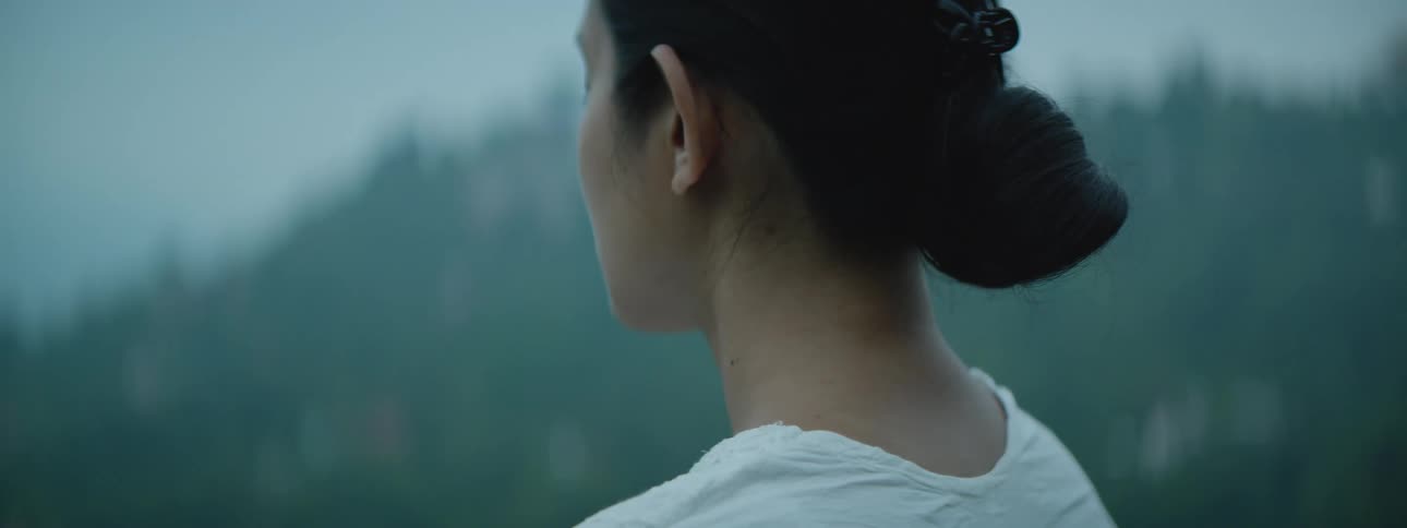 A woman is meditating outdoors during the spring time