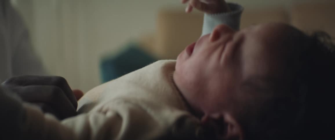 Father with white t shirt babysits crying baby