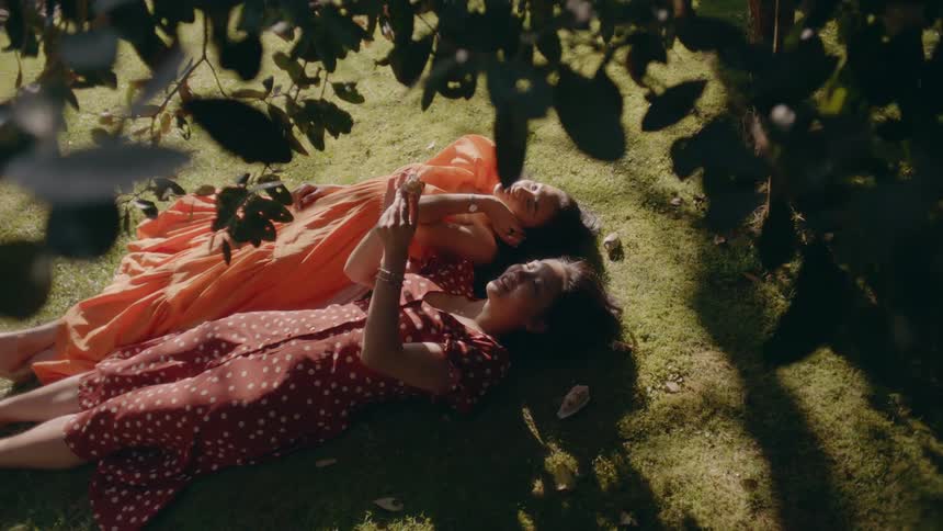 Two friends are laying in the grass together in spring
