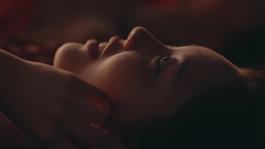 A woman is laying down and smiling