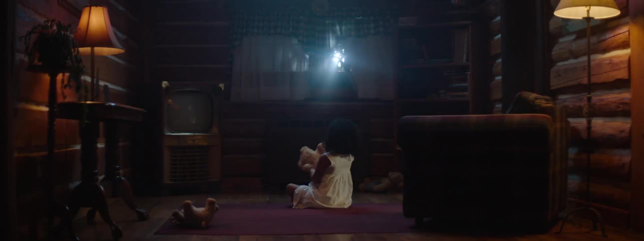 Mysterious light shines through window while a child is playing with a stuffed animal