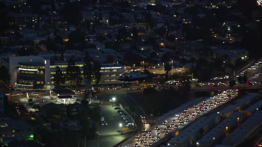 A LAPD helicopter is tracked through Hollywood at twilight in Southern California
