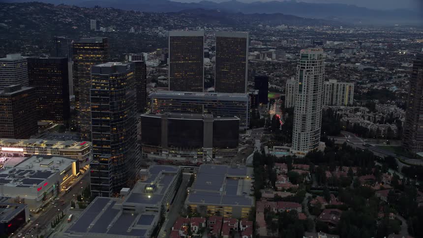 Aerial footage of Century Citys towering office buildings and skyscrapers during sunset shot over Californias west coast