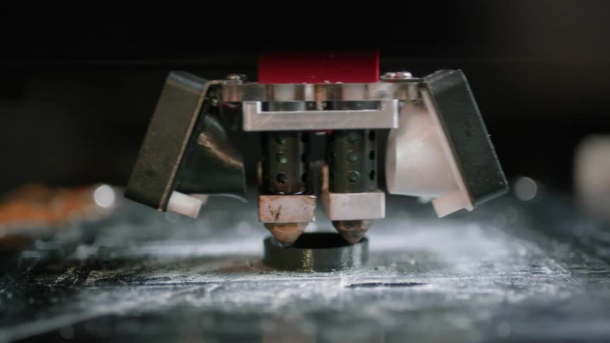 A close up of a machine creating a 3d product