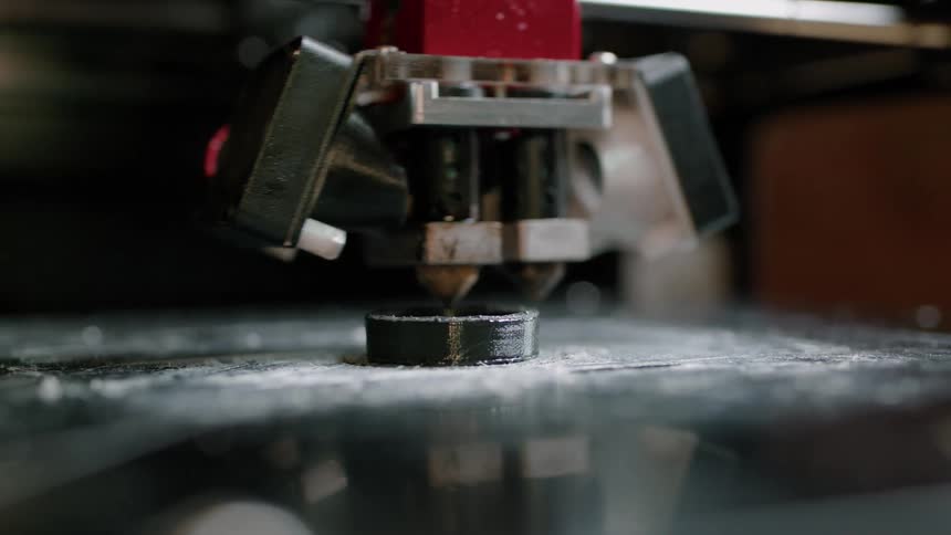 A close up of a machine creating a 3d product