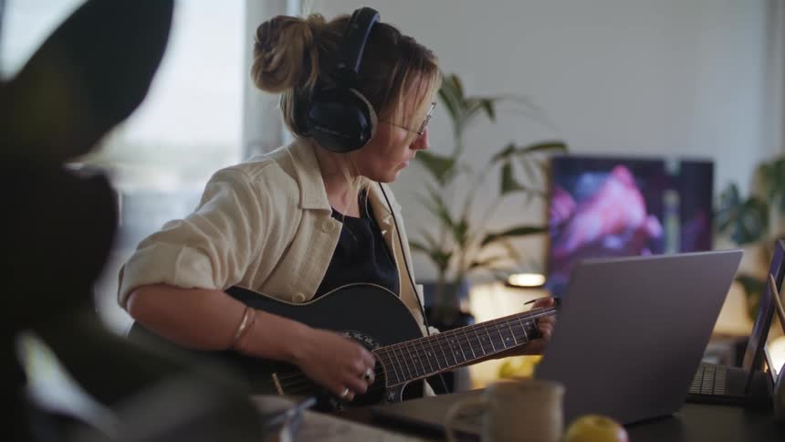 A woman is playing the guitar