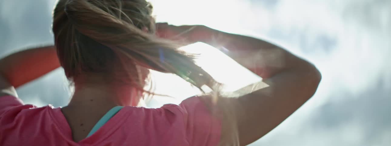 Woman shading her eyes looking into the sunshine