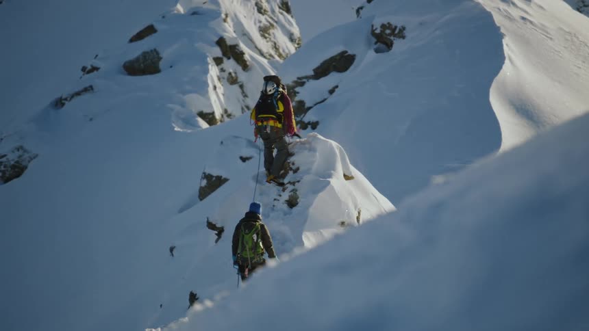 Winter Mountain Climb: Two Adventurers Scaling the Peaks