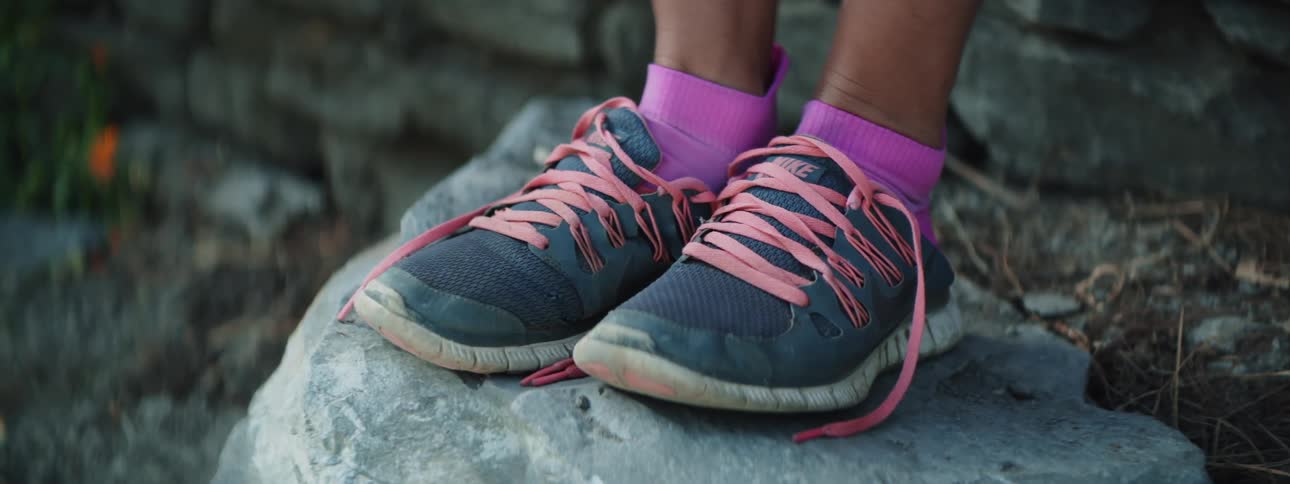 A person puts on their sneakers