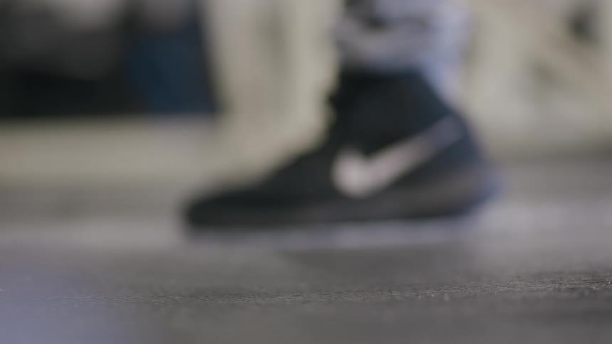 Close up of weightlifting weights hitting the floor and bouncing