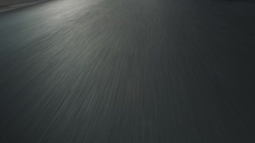Wide road stretches in front of motorcycle wheel
