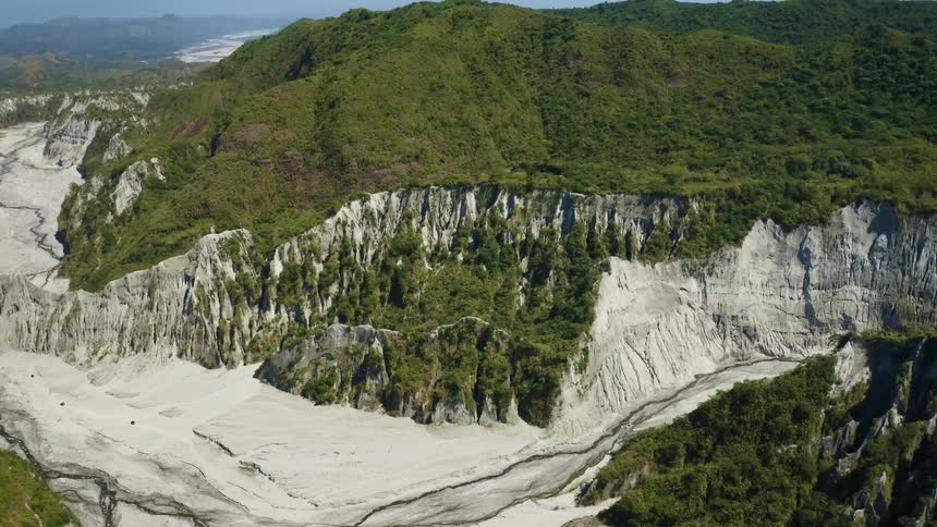 Trees grow along sides and top of a vast canyon