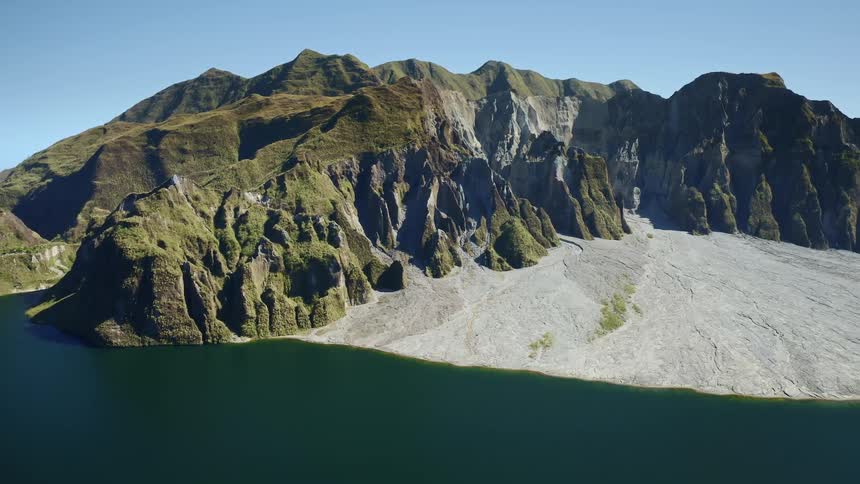 A sense of rugged beauty and tranquility fills the scene with a lonely rocky place with water flowing beneath it