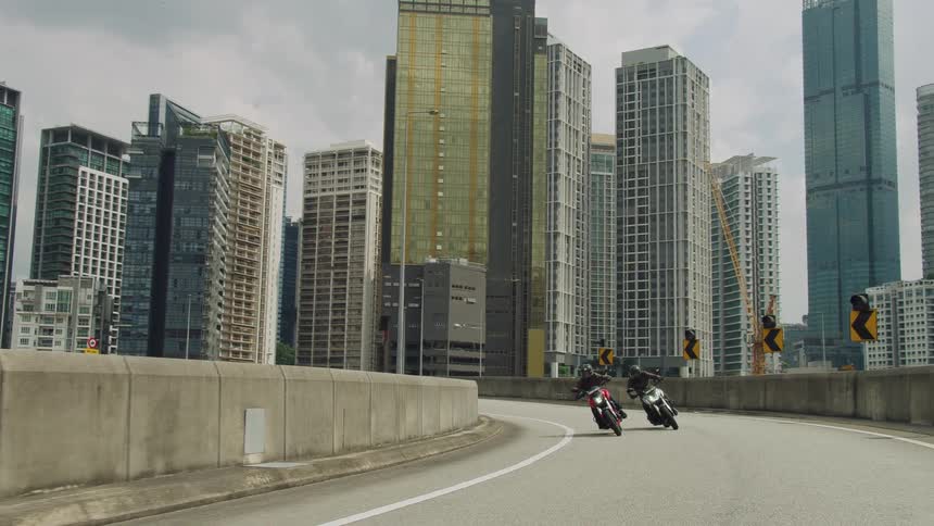 Slow motion view of two motorcycles driving through a city