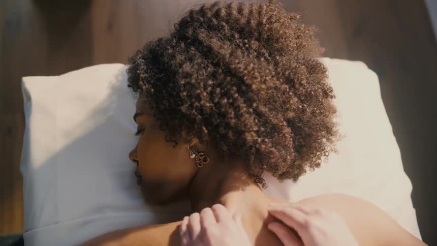 Black woman getting a massage at a spa