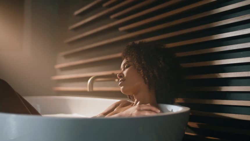 A woman is relaxing in a bathtub filled with water