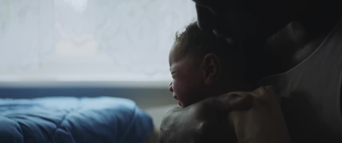 A father rocks his crying baby