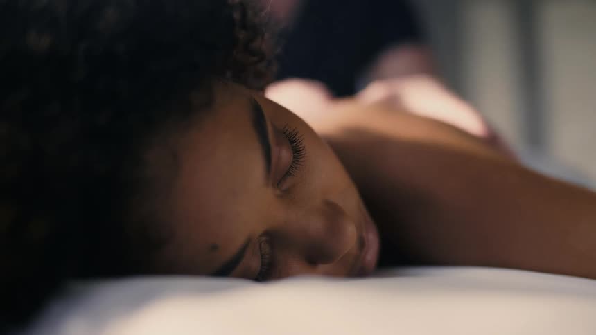 Close-up of Beautiful black woman relaxing while getting a massage at a spa