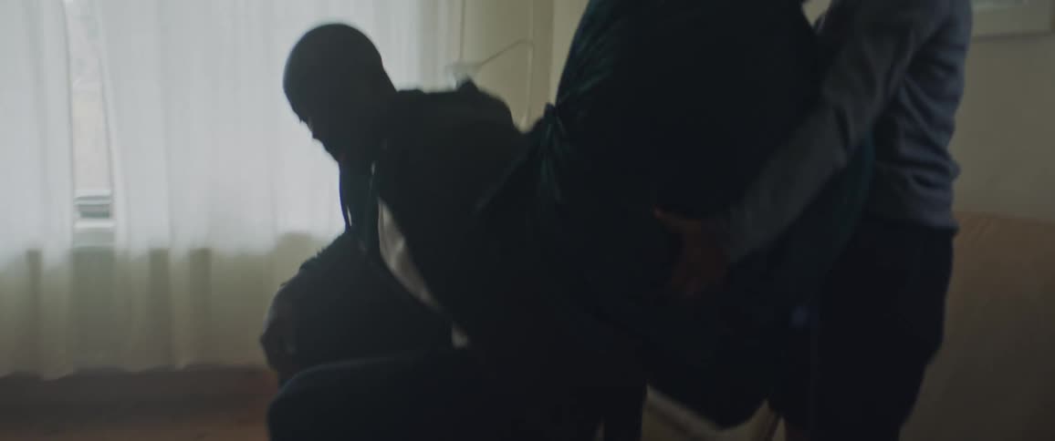 Father and son pillow fighting in the couch on the living room at home