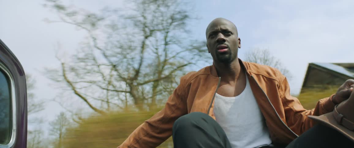 A man is riding in the back of the pickup truck