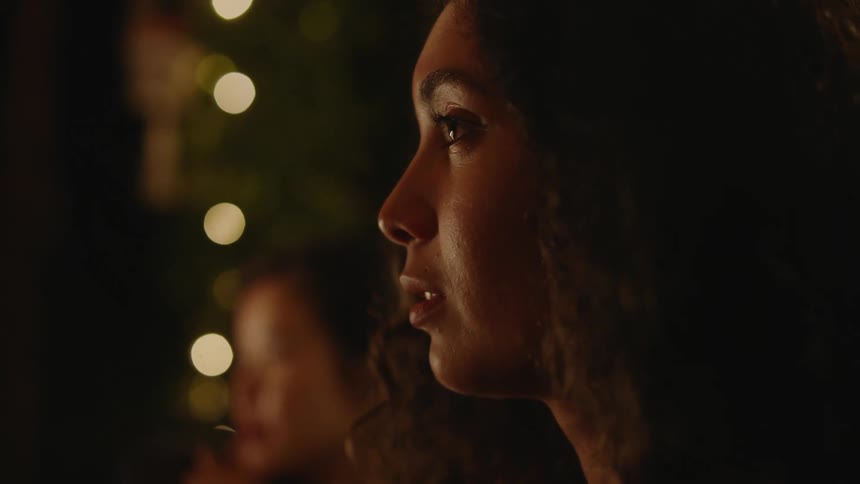 Two women are talking and sitting outdoors