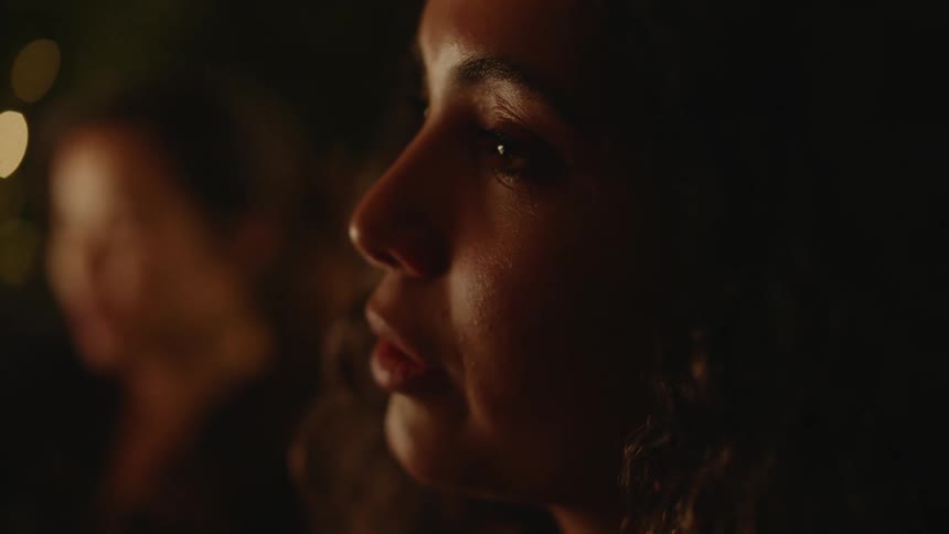 A close up of a womans face smiling and looking at something