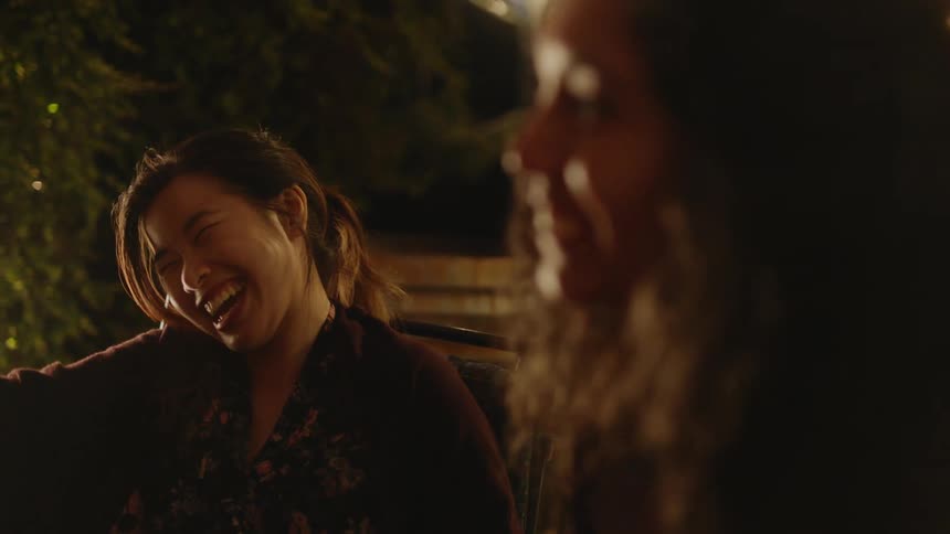 Two friends are laughing and talking to eachother