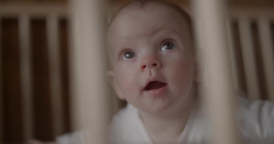 A baby is in a crib