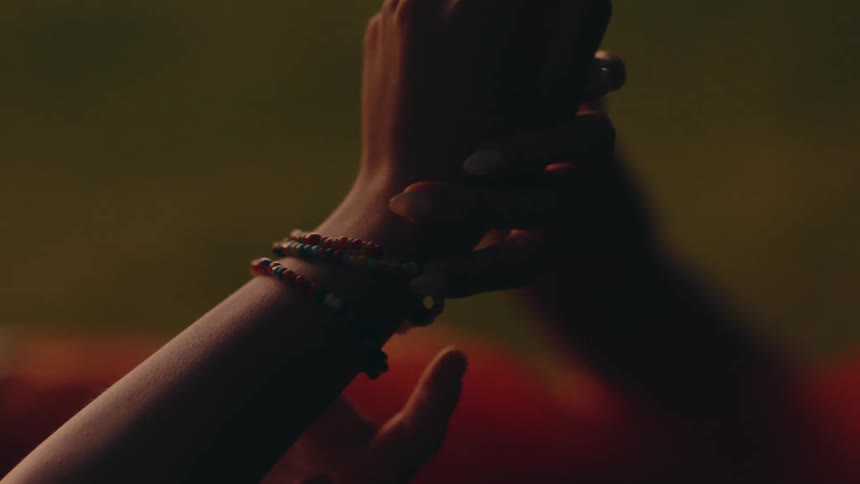 Girls wearing bracelets lets a friend admire them