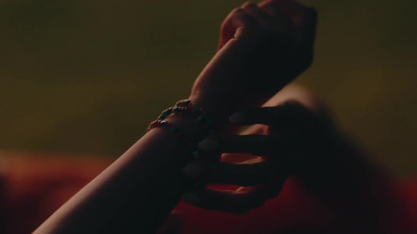 A person examines someones bracelet