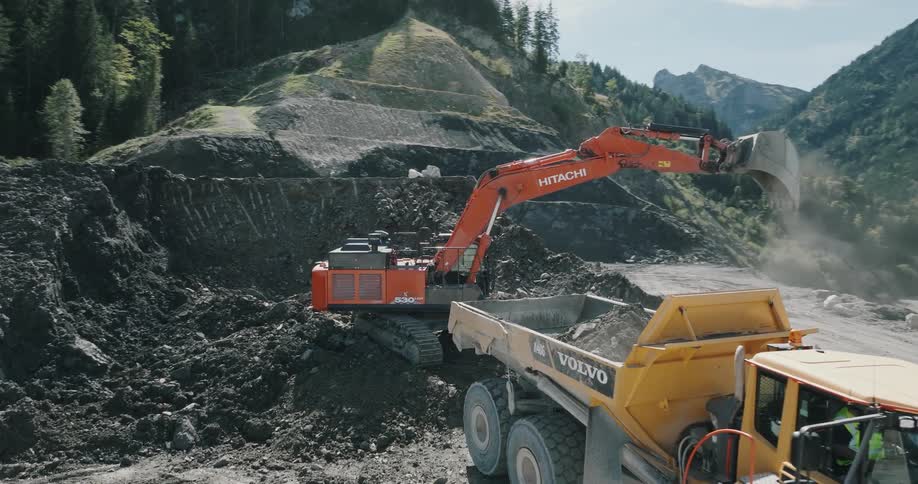 A machine is shown in action as it packs sand into a truck most likely at a construction site